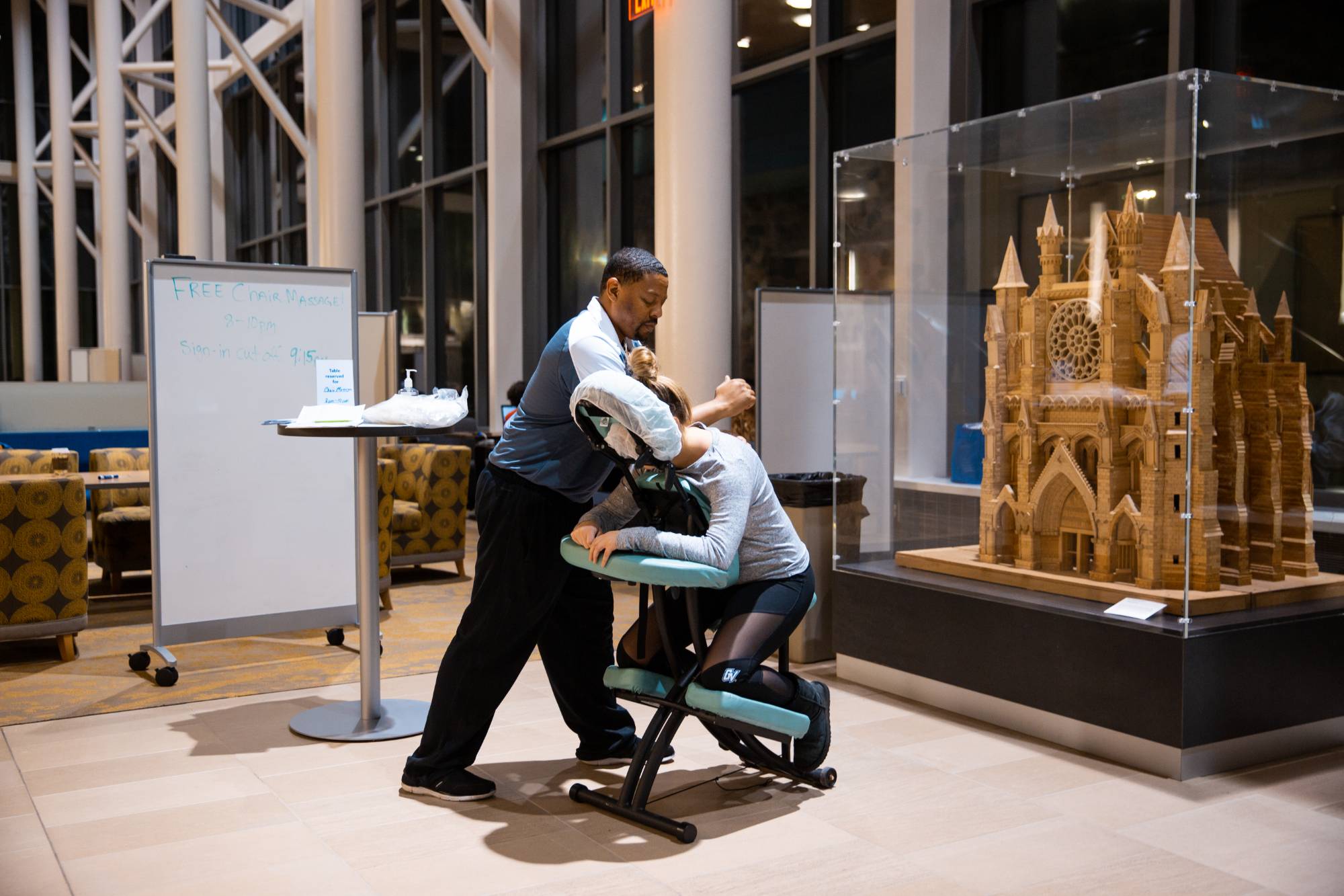 A student receiving a chair massage in the Mary Idema Pew library during Exam Cram.
